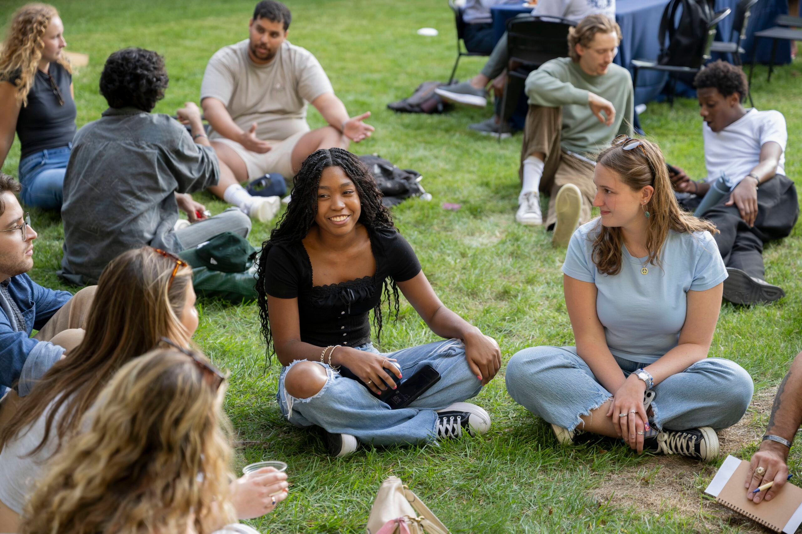 students gather on a lawn